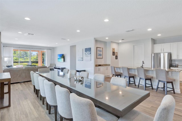7519 Marker Ave, Kissimmee, FL 34747 - dining space with recessed lighting, visible vents, and light wood-type flooring