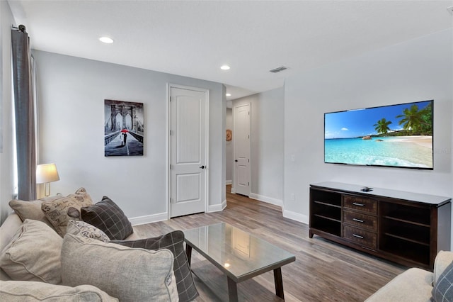 7519 Marker Ave, Kissimmee, FL 34747 - living room featuring recessed lighting, baseboards, visible vents, and wood finished floors