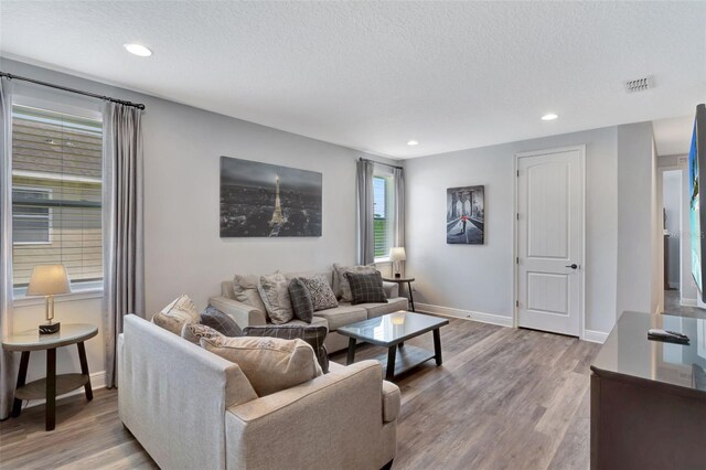 7519 Marker Ave, Kissimmee, FL 34747 - living room with a textured ceiling, recessed lighting, visible vents, and wood finished floors
