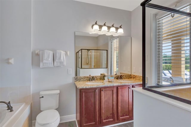 7519 Marker Ave, Kissimmee, FL 34747 - bathroom with double vanity, a garden tub, toilet, a stall shower, and a sink