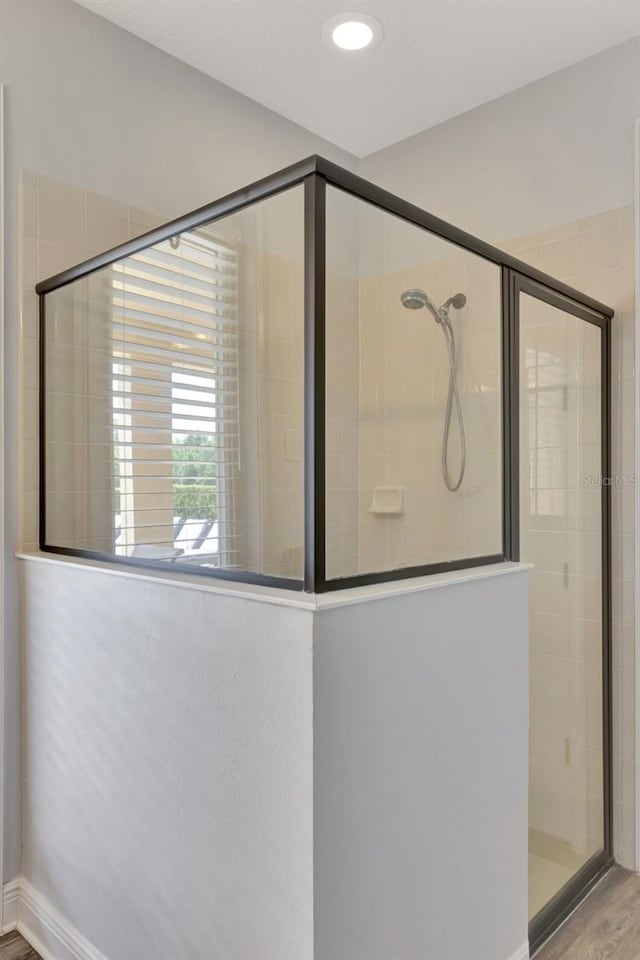 7519 Marker Ave, Kissimmee, FL 34747 - full bath with baseboards, wood finished floors, tiled shower, and recessed lighting