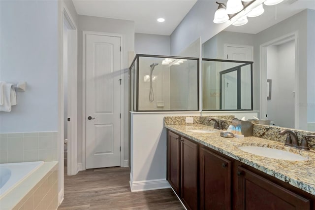 7519 Marker Ave, Kissimmee, FL 34747 - full bathroom with double vanity, a stall shower, a garden tub, and a sink