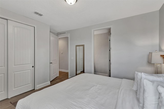 7519 Marker Ave, Kissimmee, FL 34747 - bedroom featuring baseboards, a closet, visible vents, and wood finished floors