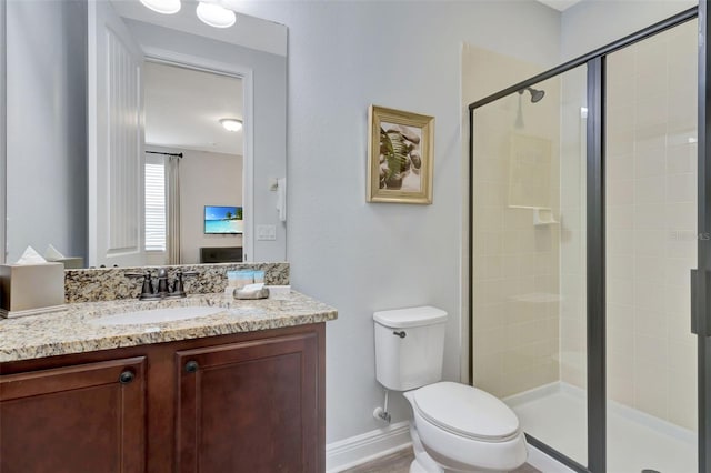 7519 Marker Ave, Kissimmee, FL 34747 - bathroom featuring vanity, toilet, baseboards, and a stall shower