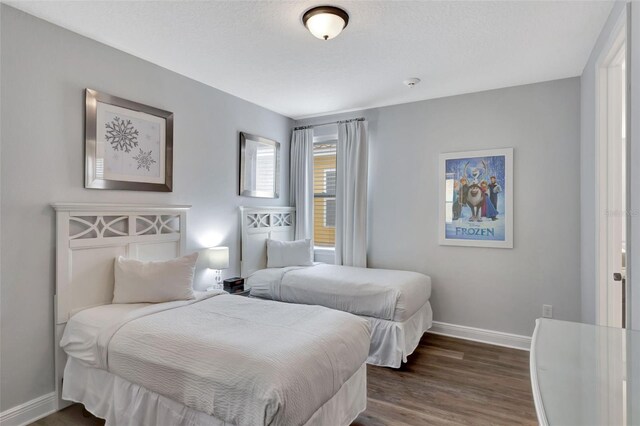 7519 Marker Ave, Kissimmee, FL 34747 - bedroom featuring dark wood-style flooring and baseboards