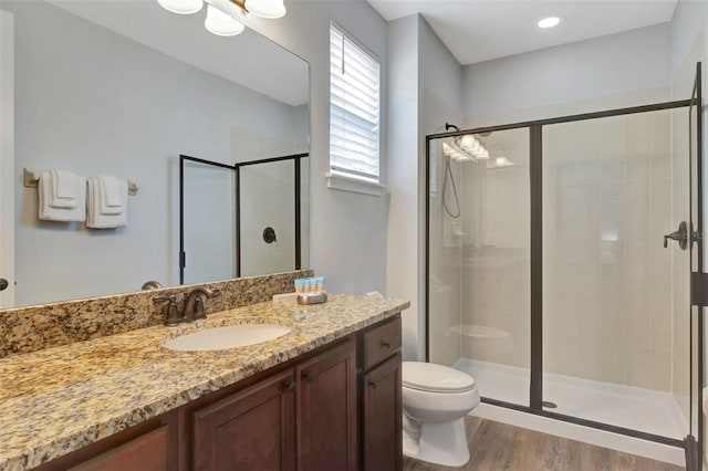 7519 Marker Ave, Kissimmee, FL 34747 - bathroom featuring a stall shower, vanity, toilet, and wood finished floors
