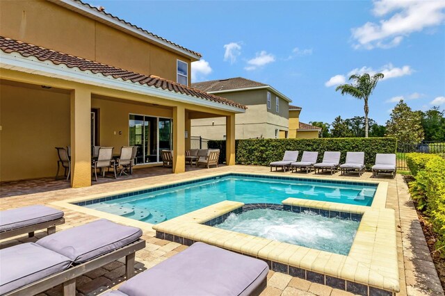 7519 Marker Ave, Kissimmee, FL 34747 - view of pool with a pool with connected hot tub, fence, a patio, and outdoor dining area