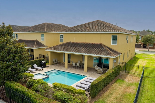 7519 Marker Ave, Kissimmee, FL 34747 - rear view of property with a patio area, stucco siding, a fenced backyard, a tiled roof, and a lawn
