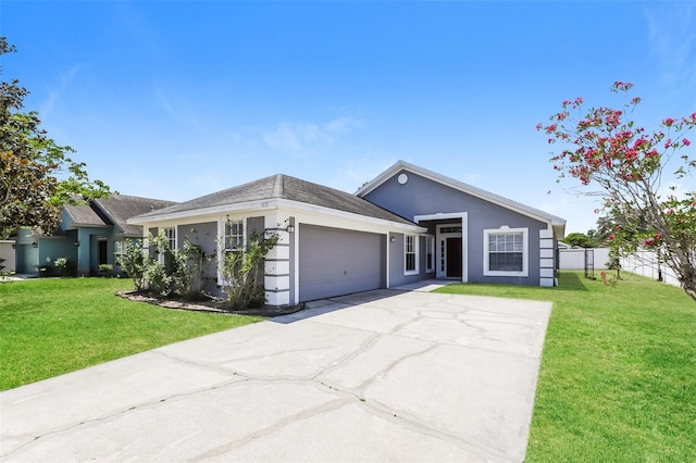 1653 Turtle Rock Dr, Lakeland, FL 33803 - single story home featuring concrete driveway, an attached garage, stucco siding, and a front lawn