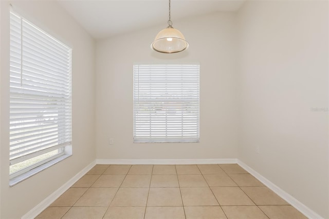 1653 Turtle Rock Dr, Lakeland, FL 33803 - spare room featuring baseboards, vaulted ceiling, and light tile patterned flooring