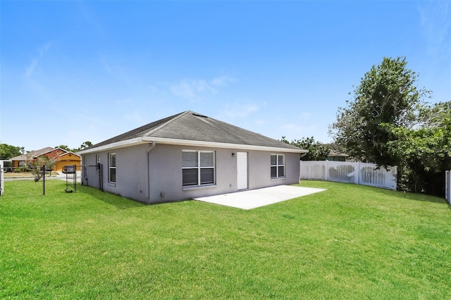 1653 Turtle Rock Dr, Lakeland, FL 33803 - rear view of property with a lawn, a fenced backyard, a patio area, and stucco siding