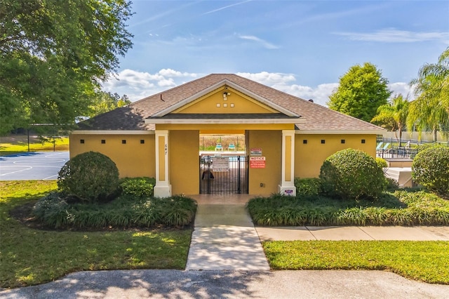 view of front of house featuring fence and stucco siding