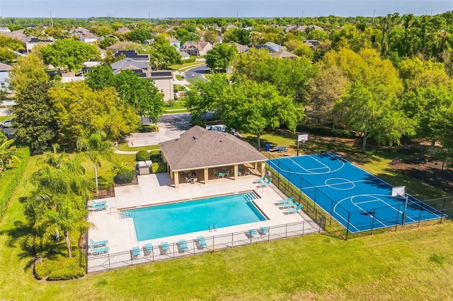 community pool with fence, a patio, and a lawn