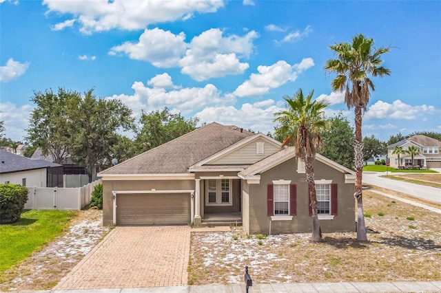 807 Ayden Oak Ln, Ocoee, FL 34761 - single story home with fence, an attached garage, stucco siding, a gate, and decorative driveway