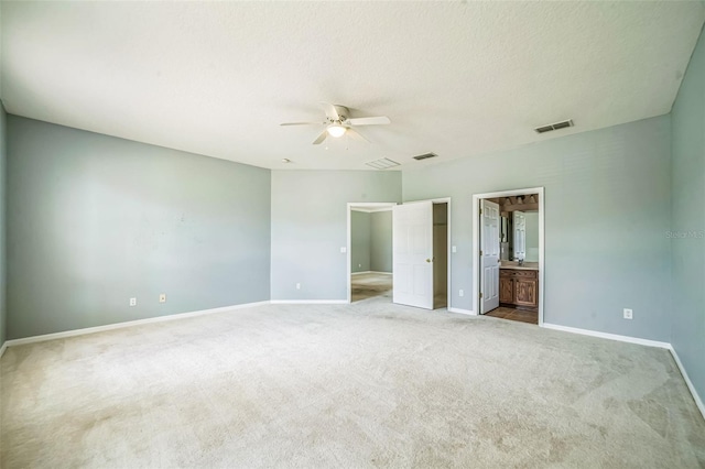 807 Ayden Oak Ln, Ocoee, FL 34761 - unfurnished bedroom featuring visible vents, baseboards, connected bathroom, a ceiling fan, and carpet