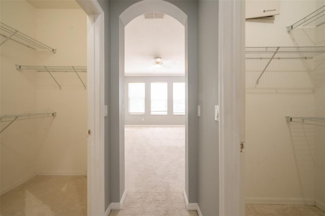 807 Ayden Oak Ln, Ocoee, FL 34761 - spacious closet featuring arched walkways, visible vents, and light carpet