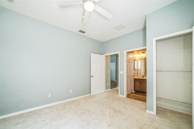 807 Ayden Oak Ln, Ocoee, FL 34761 - unfurnished bedroom with light carpet, a sink, ensuite bathroom, visible vents, and a closet