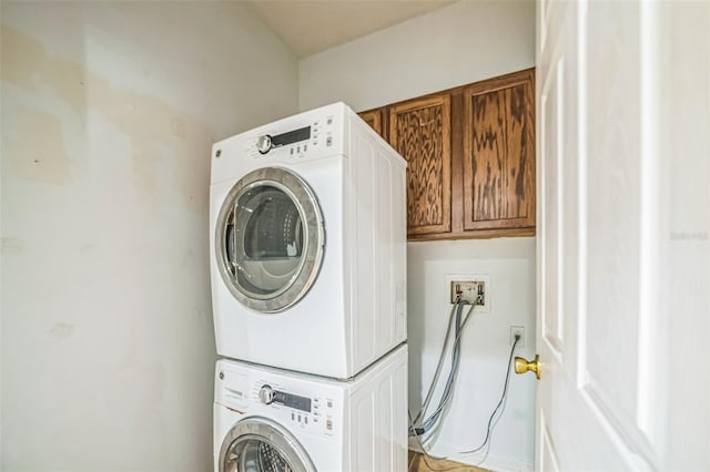 807 Ayden Oak Ln, Ocoee, FL 34761 - laundry room featuring cabinet space and stacked washer and clothes dryer
