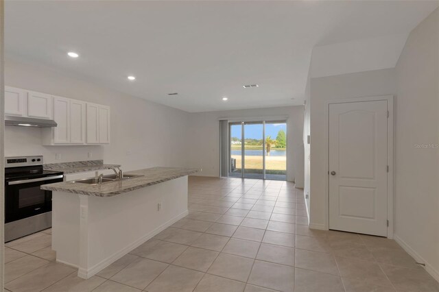 1089 Blue Jay Dr, Davenport, FL 33837 - kitchen with a sink, under cabinet range hood, open floor plan, stainless steel electric range oven, and light tile patterned floors