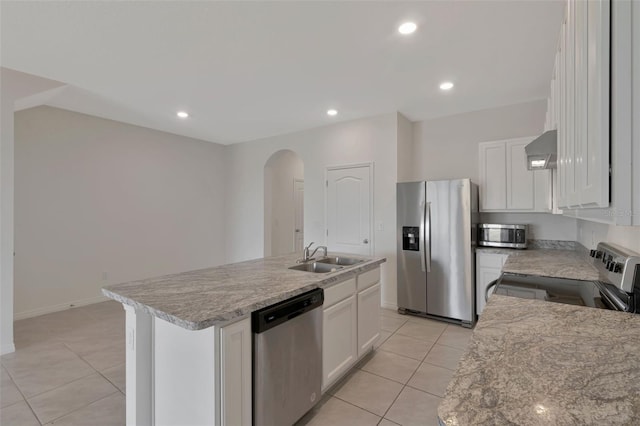1089 Blue Jay Dr, Davenport, FL 33837 - kitchen featuring arched walkways, stainless steel appliances, light tile patterned floors, and a sink