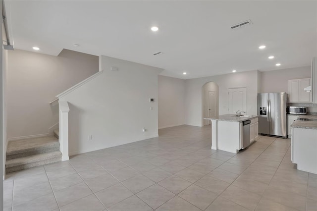 1089 Blue Jay Dr, Davenport, FL 33837 - kitchen with open floor plan, visible vents, arched walkways, appliances with stainless steel finishes, and recessed lighting