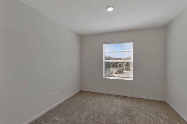 1089 Blue Jay Dr, Davenport, FL 33837 - unfurnished room with light carpet and baseboards