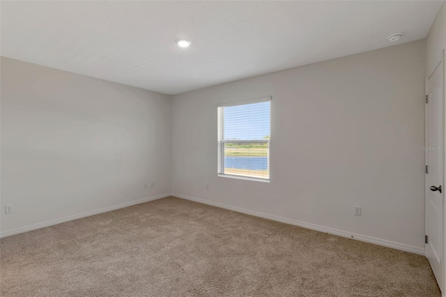 1089 Blue Jay Dr, Davenport, FL 33837 - unfurnished room with baseboards and light colored carpet