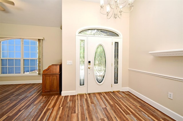 entrance foyer featuring baseboards, ceiling fan with notable chandelier, and wood finished floors