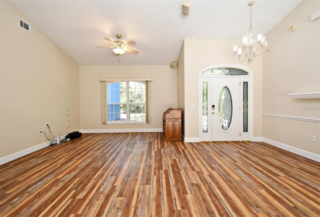 foyer entrance featuring baseboards, ceiling fan with notable chandelier, wood finished floors, and visible vents