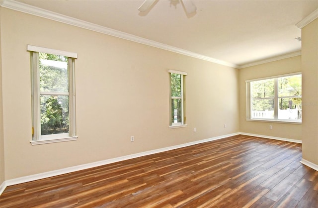 empty room featuring crown molding, baseboards, plenty of natural light, and dark wood-style flooring