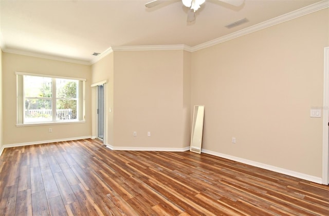 empty room featuring baseboards, ornamental molding, a ceiling fan, and wood finished floors