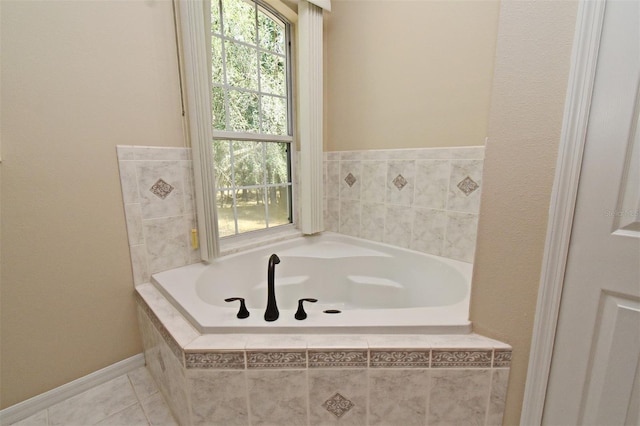 bathroom with a bath and tile patterned floors