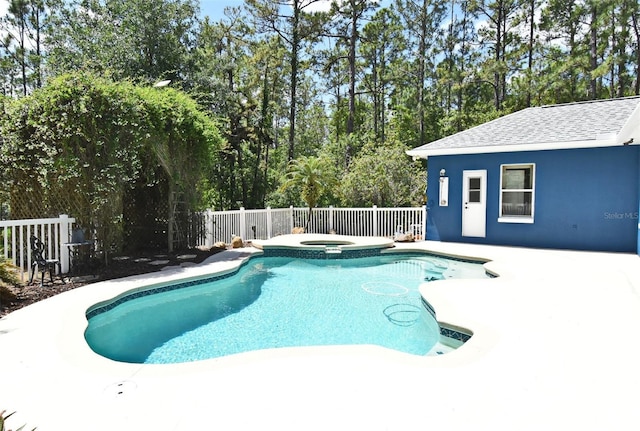 view of swimming pool with fence, an in ground hot tub, a fenced in pool, and a patio