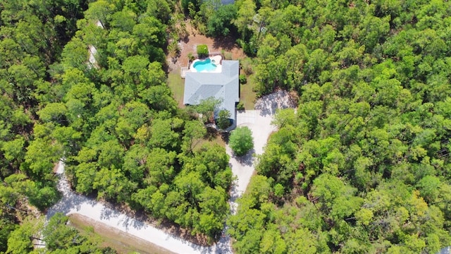 drone / aerial view with a wooded view