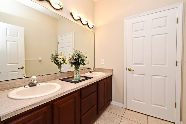 bathroom featuring a sink, tile patterned floors, and double vanity