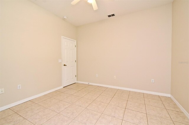 unfurnished room with baseboards, ceiling fan, visible vents, and light tile patterned floors