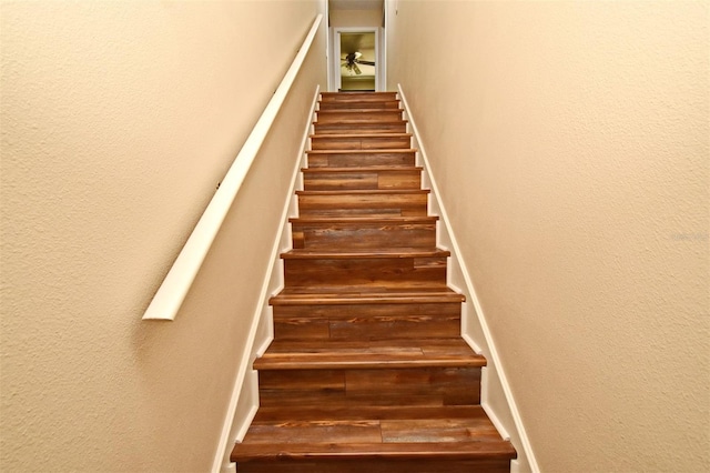stairs featuring a textured wall