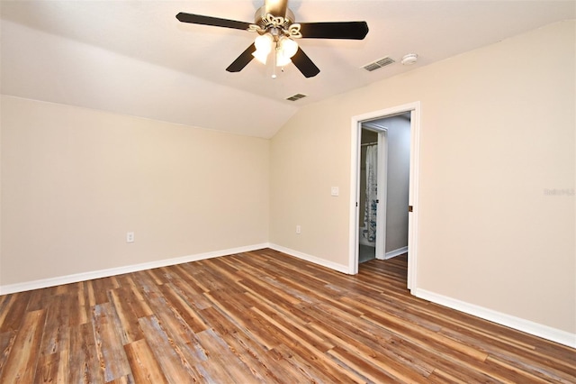 spare room featuring a ceiling fan, baseboards, visible vents, and lofted ceiling