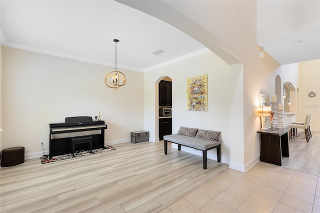 15485 Sandfield Loop, Winter Garden, FL 34787 - living area featuring arched walkways, ornamental molding, baseboards, and light wood finished floors