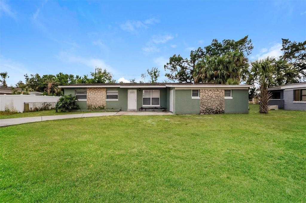 1108 Jordan Ave, Orlando, FL 32809 - view of front of property with a front lawn, stucco siding, driveway, and fence