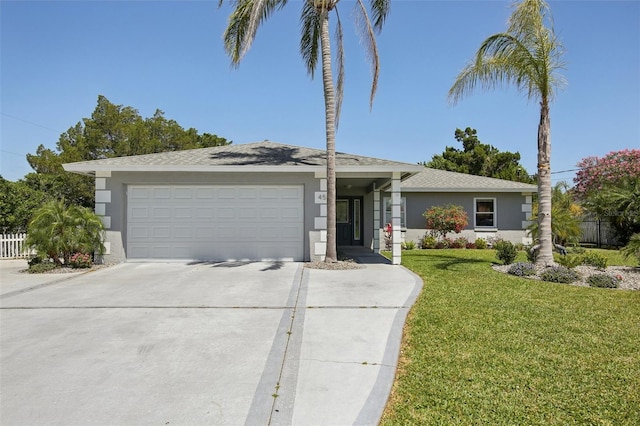 view of front of house with a garage, fence, a front yard, stucco siding, and concrete driveway