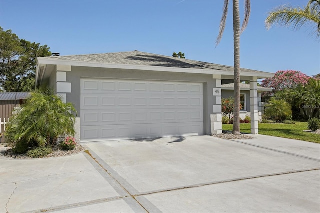 garage featuring concrete driveway
