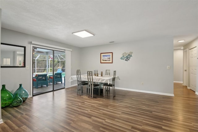 dining room featuring baseboards and wood finished floors