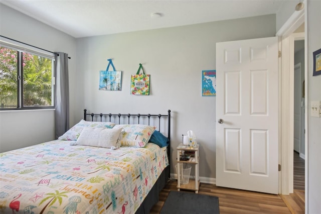 bedroom with wood finished floors