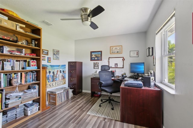 office featuring visible vents, baseboards, ceiling fan, and wood finished floors