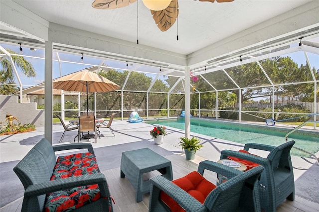 pool with a patio, a lanai, ceiling fan, and fence