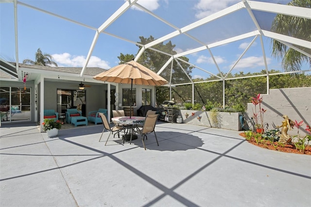 view of patio / terrace featuring outdoor dining space, ceiling fan, and glass enclosure