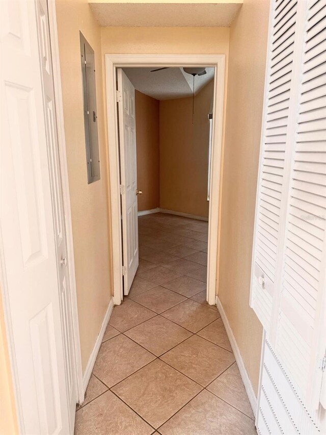 1621 Emily Ct, Kissimmee, FL 34744 - hall with electric panel and light tile patterned floors