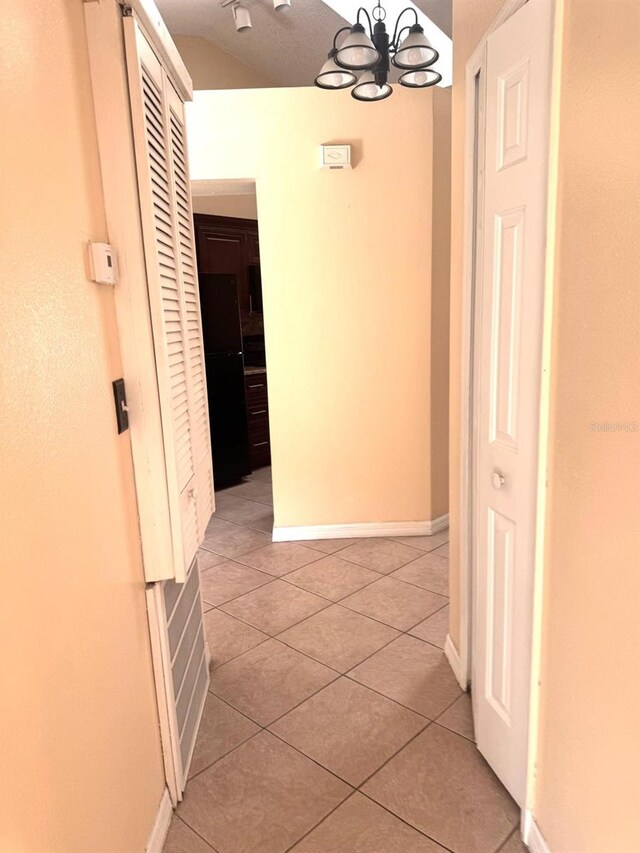 1621 Emily Ct, Kissimmee, FL 34744 - corridor with light tile patterned floors and a chandelier