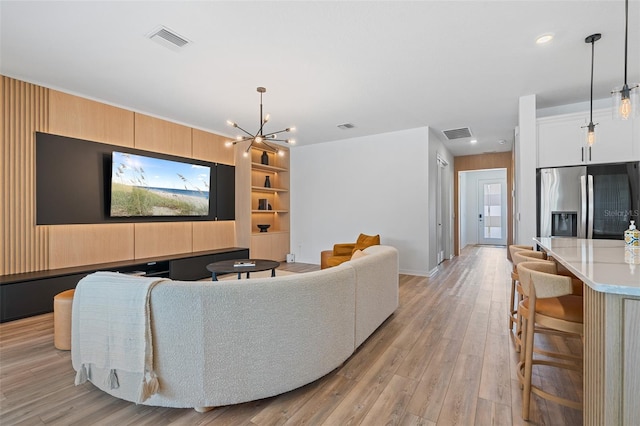8105 Fenton St, Orlando, FL 32836 - living room featuring a chandelier, light wood-style flooring, baseboards, recessed lighting, and built in shelves